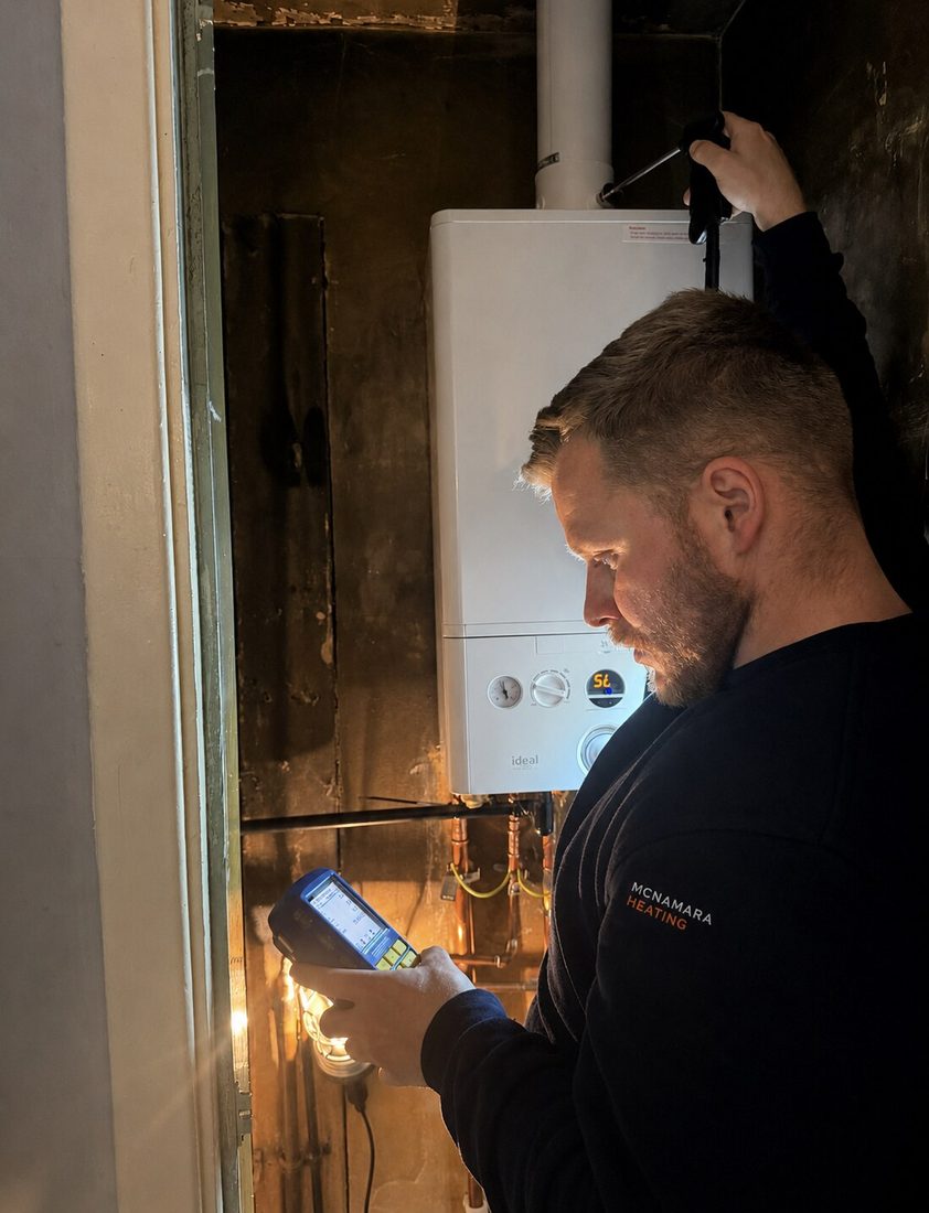 Stephen McNamara using a flue gas analyser during a boiler service in Greater Manchester
